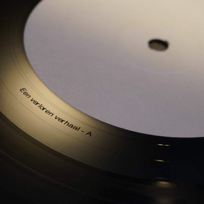 Close-up of a vinyl record label with text on a dark background